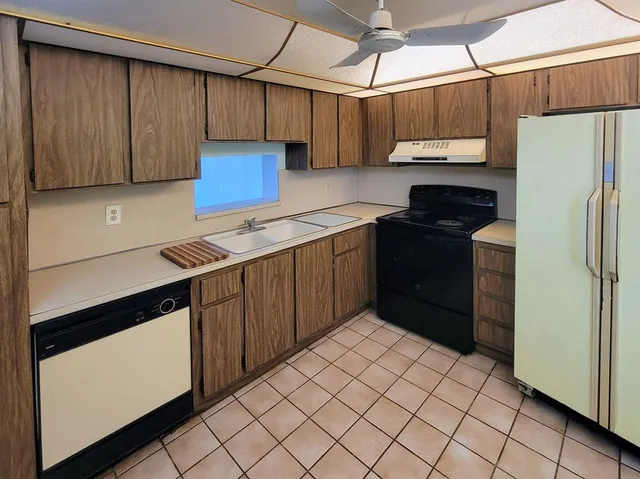 a kitchen with a refrigerator and a stove