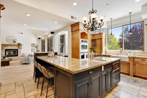 a large kitchen with a center island and some chairs