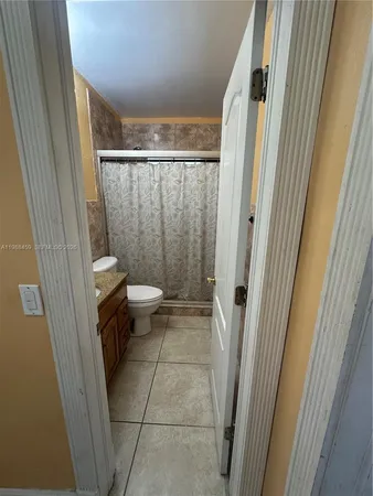 a bathroom with a granite countertop shower and a sink