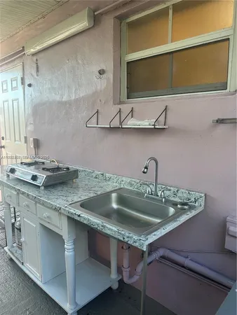a kitchen with a sink and cabinets