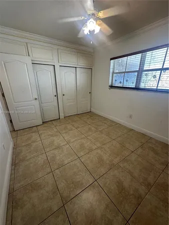 a view of a livingroom with an empty space and a window