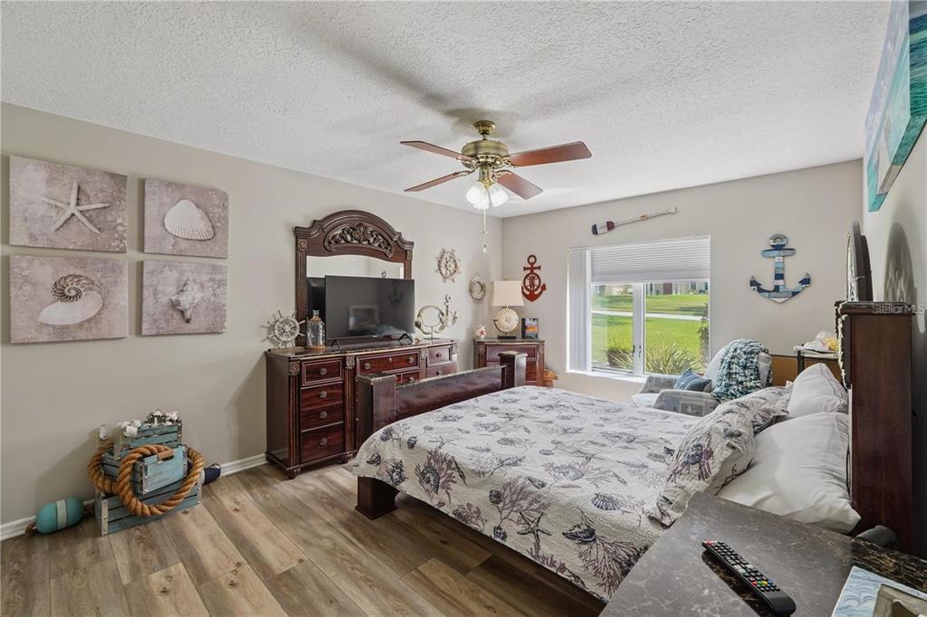 4603 Lake In The Woods Drive Spring Hill, FL 34607 - Photo 35 of 69 a bedroom with a bed and a flat screen tv