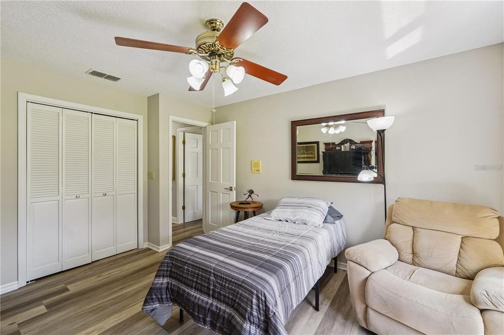 4603 Lake In The Woods Drive Spring Hill, FL 34607 - Photo 36 of 69 a bedroom with a bed and lamp