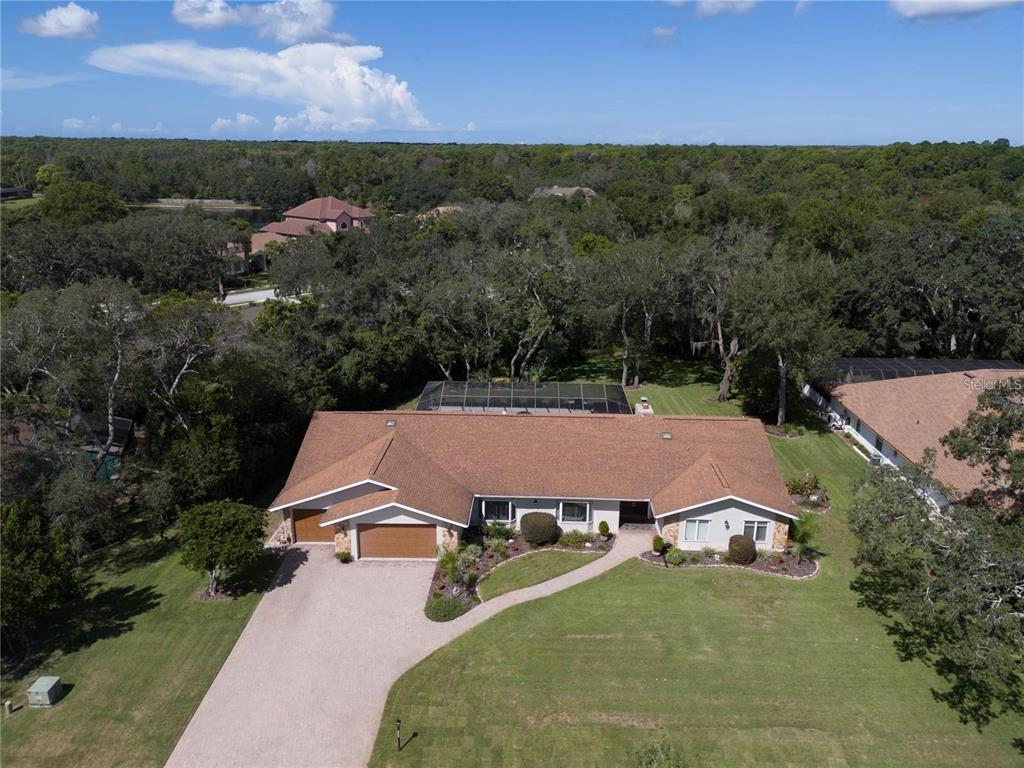4603 Lake In The Woods Drive Spring Hill, FL 34607 - Photo 49 of 69 an aerial view of a house with a yard