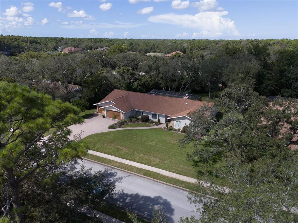 4603 Lake In The Woods Drive Spring Hill, FL 34607 - Photo 51 of 69 an aerial view of a house with a yard