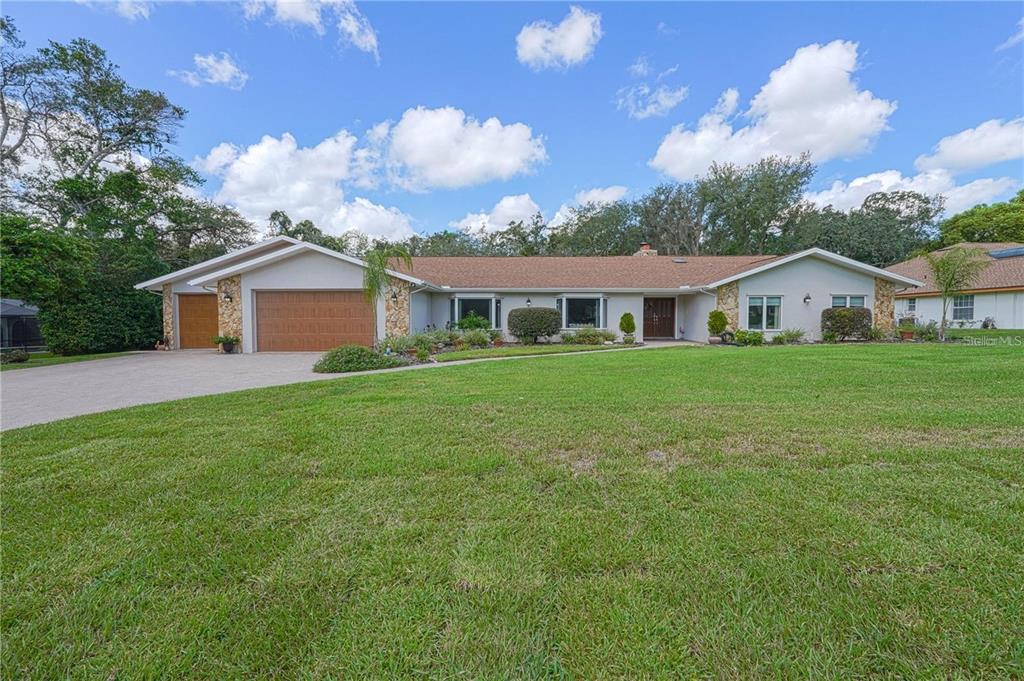 4603 Lake In The Woods Drive Spring Hill, FL 34607 - Photo 68 of 69 a front view of a house with garden