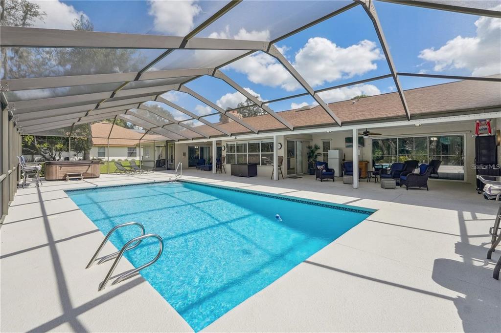4603 Lake In The Woods Drive Spring Hill, FL 34607 - Photo 69 of 69 a view of a patio with a table and chairs under an umbrella
