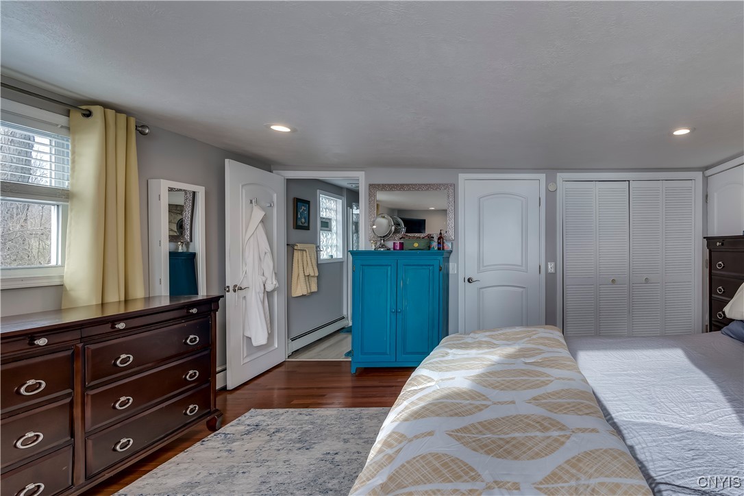 26995 3 Mile Point Road Lyme, NY 13622 - Photo 23 of 48 Primary bedroom w/ hardwood floor & walk-in closet