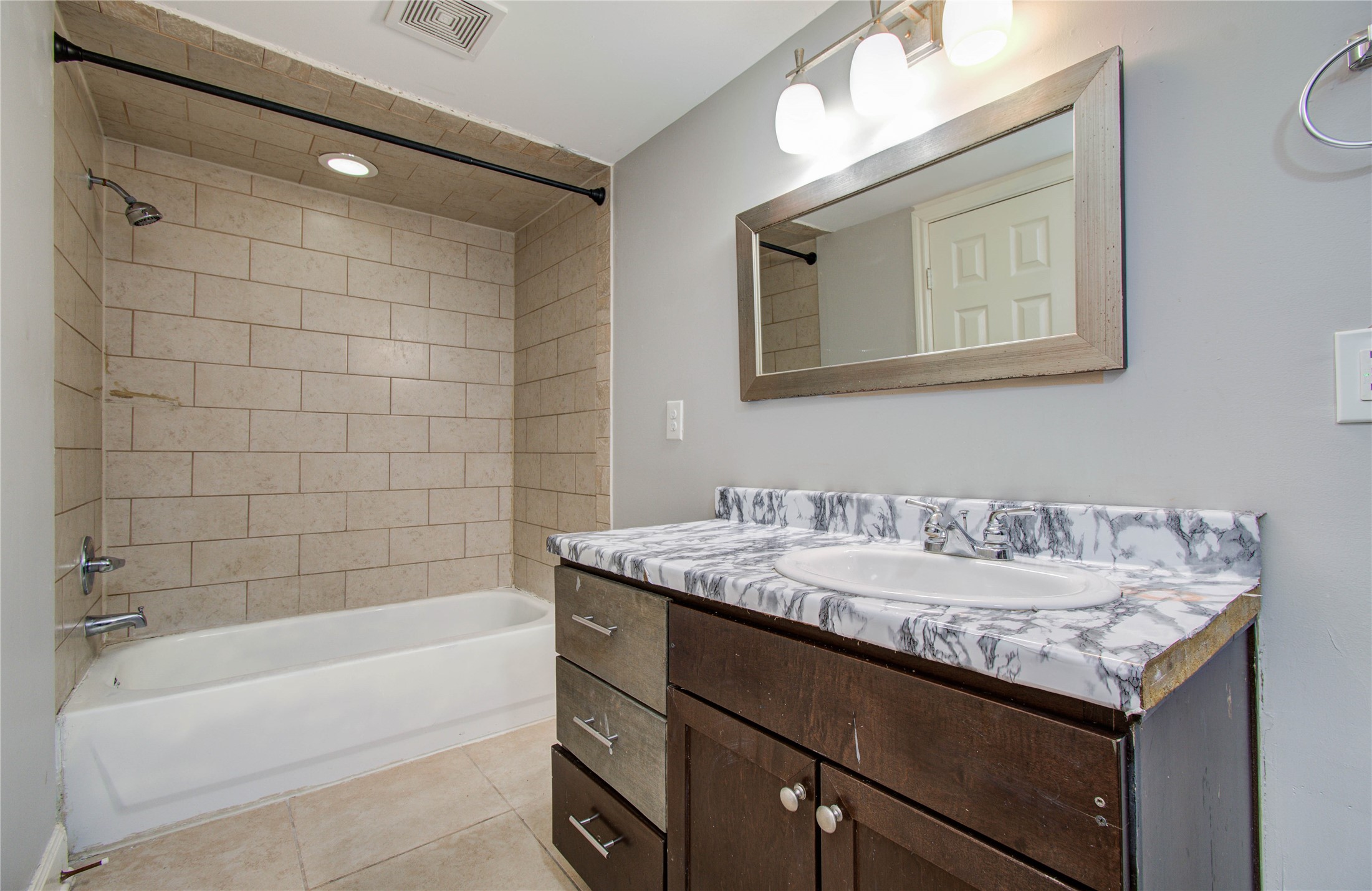 6830 New York Street Houston, TX 77021 - Photo 15 of 23 a bathroom with a granite countertop sink mirror and bathtub