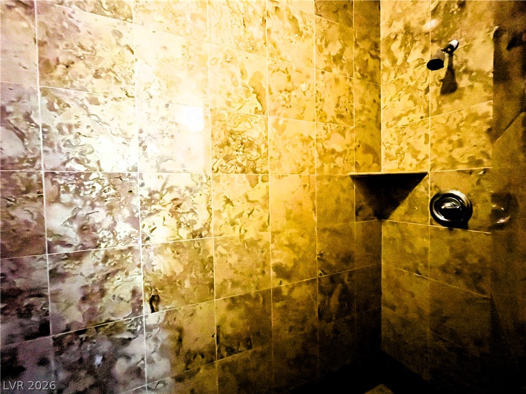 360 East Desert Inn Road, Unit 507 Las Vegas, NV 89109 - Photo 27 of 37 Elegantly tiled walls enclose this walk-in shower space.