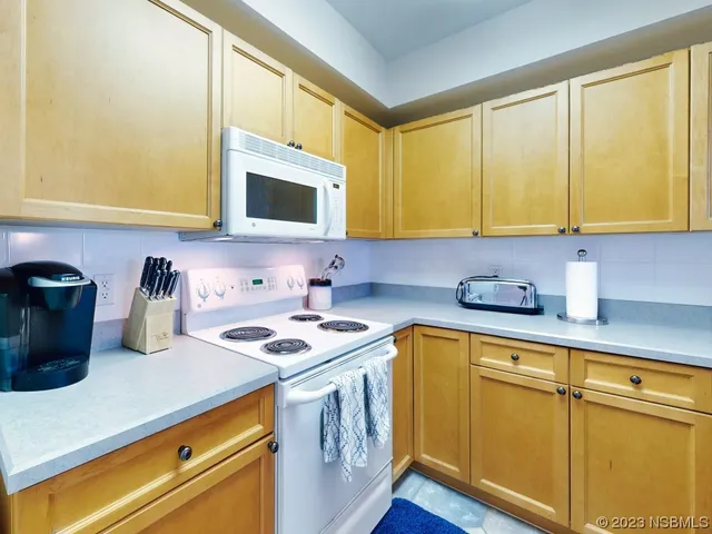 a kitchen with a sink a stove and cabinets