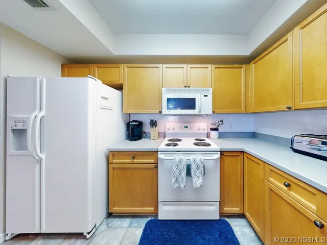 a kitchen with stainless steel appliances a refrigerator sink and cabinets