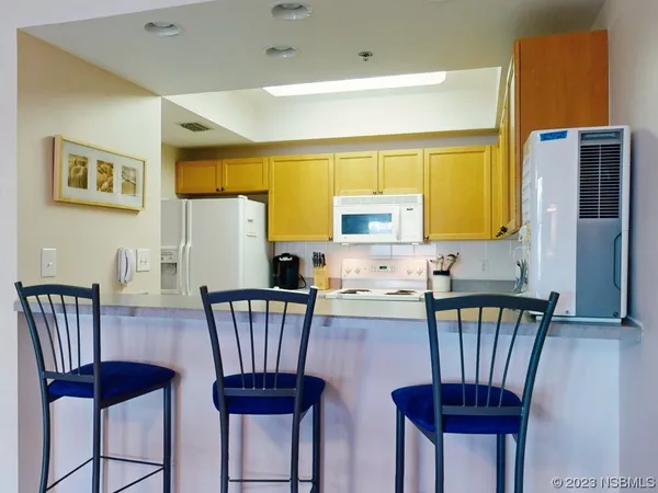 a view of a dining room with furniture and a potted plant