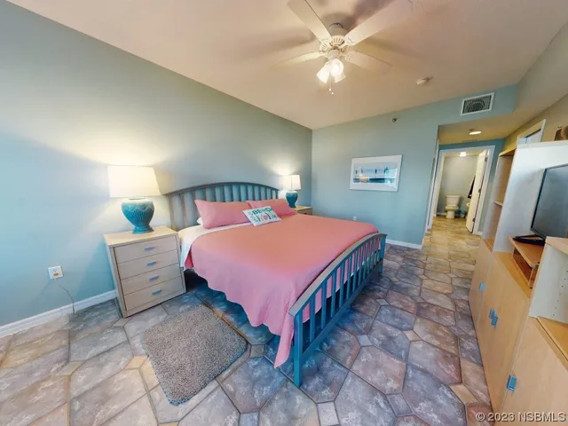 a bed room with a bed and a chandelier