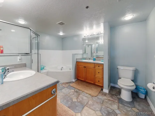 a bathroom with a sink toilet vanity and tub