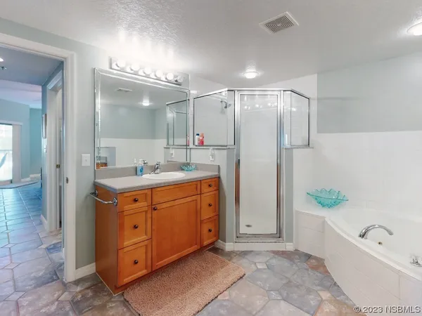 a bathroom with a double vanity sink mirror double and shower