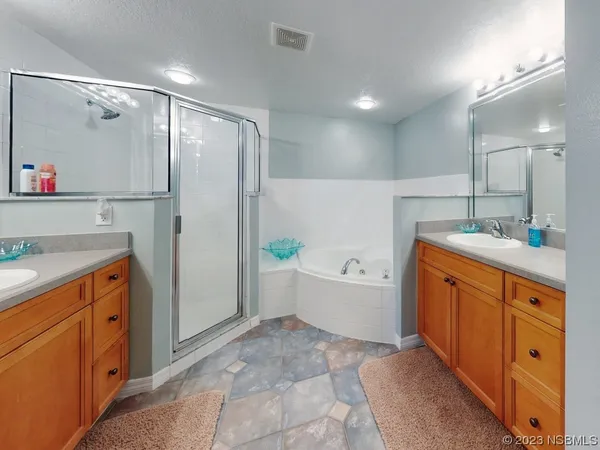 a bathroom with a granite countertop sink mirror bathtub and shower