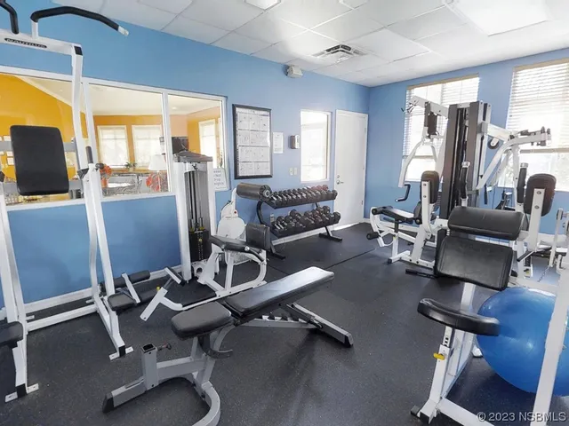 a view of a livingroom with workspace and a window