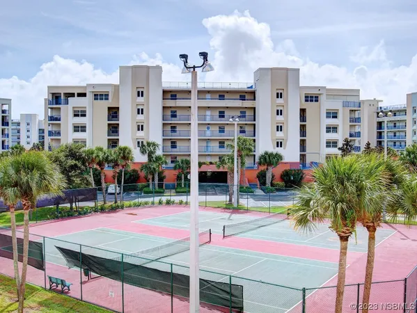 a view of a house with pool and sitting area