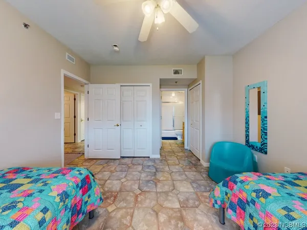 a bedroom that has a bed and a dresser in it