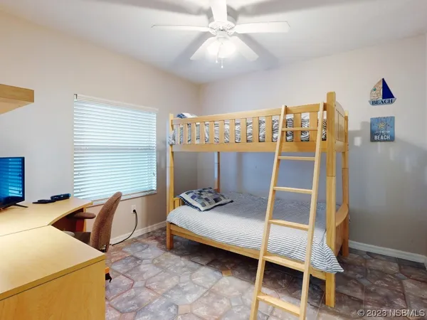 a bedroom with furniture and a ceiling fan