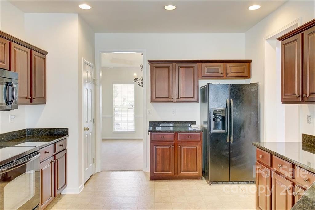 11223 Winget Pond Road Charlotte, NC 28278 - Photo 17 of 43 a kitchen with stainless steel appliances granite countertop a refrigerator and a stove