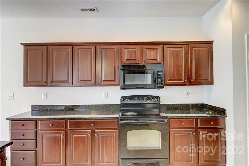 11223 Winget Pond Road Charlotte, NC 28278 - Photo 18 of 43 a kitchen with stainless steel appliances granite countertop a stove a sink and a microwave