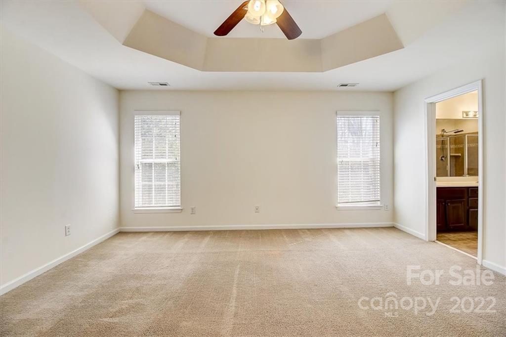 11223 Winget Pond Road Charlotte, NC 28278 - Photo 30 of 43 an empty room with chandelier fan and windows