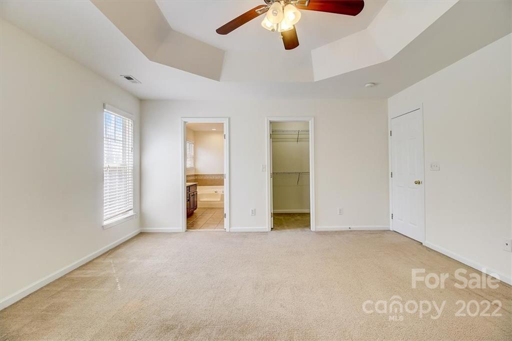 11223 Winget Pond Road Charlotte, NC 28278 - Photo 31 of 43 an empty room with chandelier fan and windows