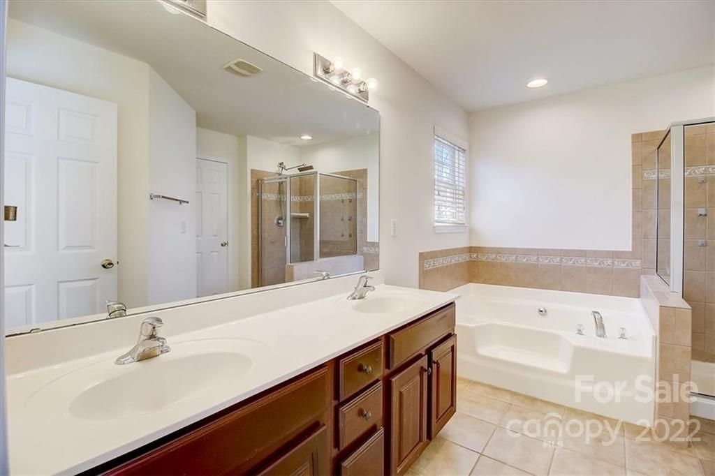 11223 Winget Pond Road Charlotte, NC 28278 - Photo 33 of 43 a bathroom with a sink double vanity granite tub shower and a mirror