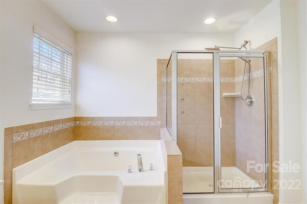 11223 Winget Pond Road Charlotte, NC 28278 - Photo 34 of 43 a bathroom with a bathtub and a shower