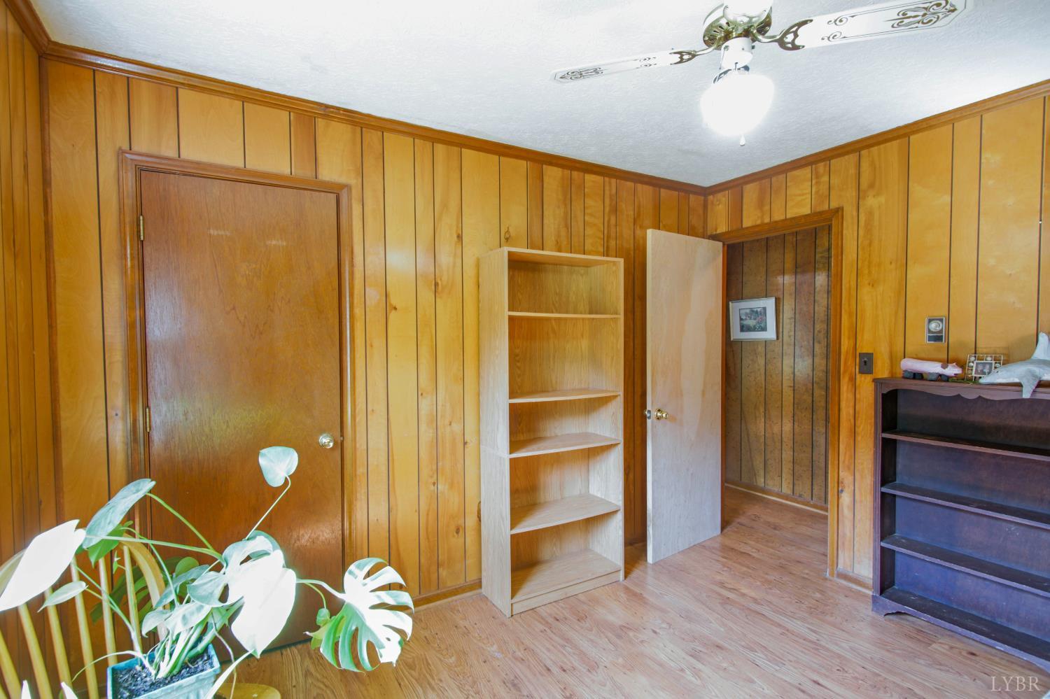 1494 Buffalo Mill Road Evington, VA 24550 - Photo 15 of 75 a bedroom with a bed and a chandelier