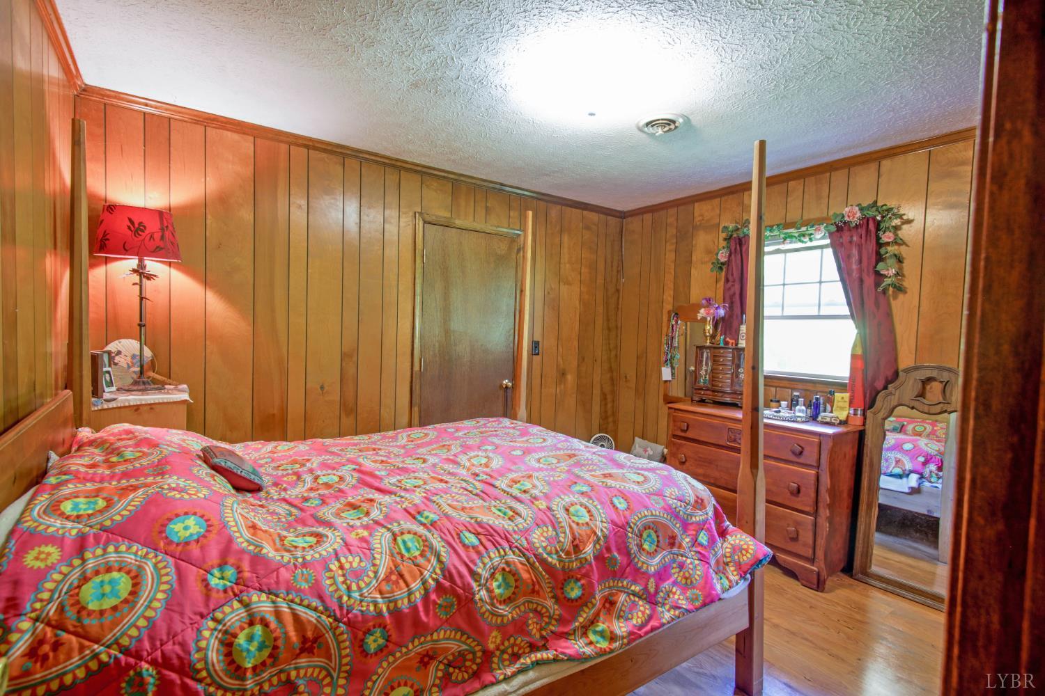 1494 Buffalo Mill Road Evington, VA 24550 - Photo 31 of 75 a bedroom with a bed and a mirror