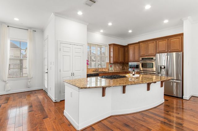 a kitchen with stainless steel appliances granite countertop a stove and a sink