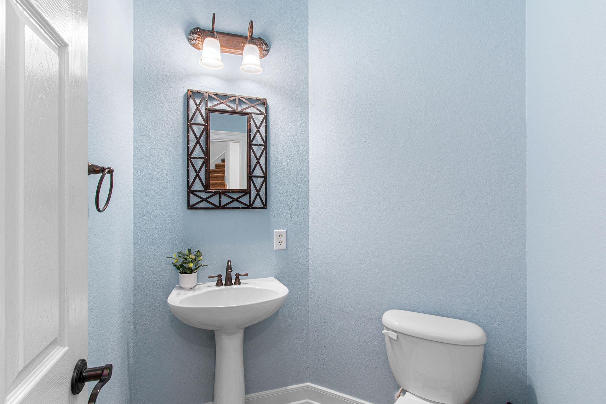 70 Shell Port Square The Woodlands, TX 77380 - Photo 20 of 50 a bathroom with a toilet sink and mirror