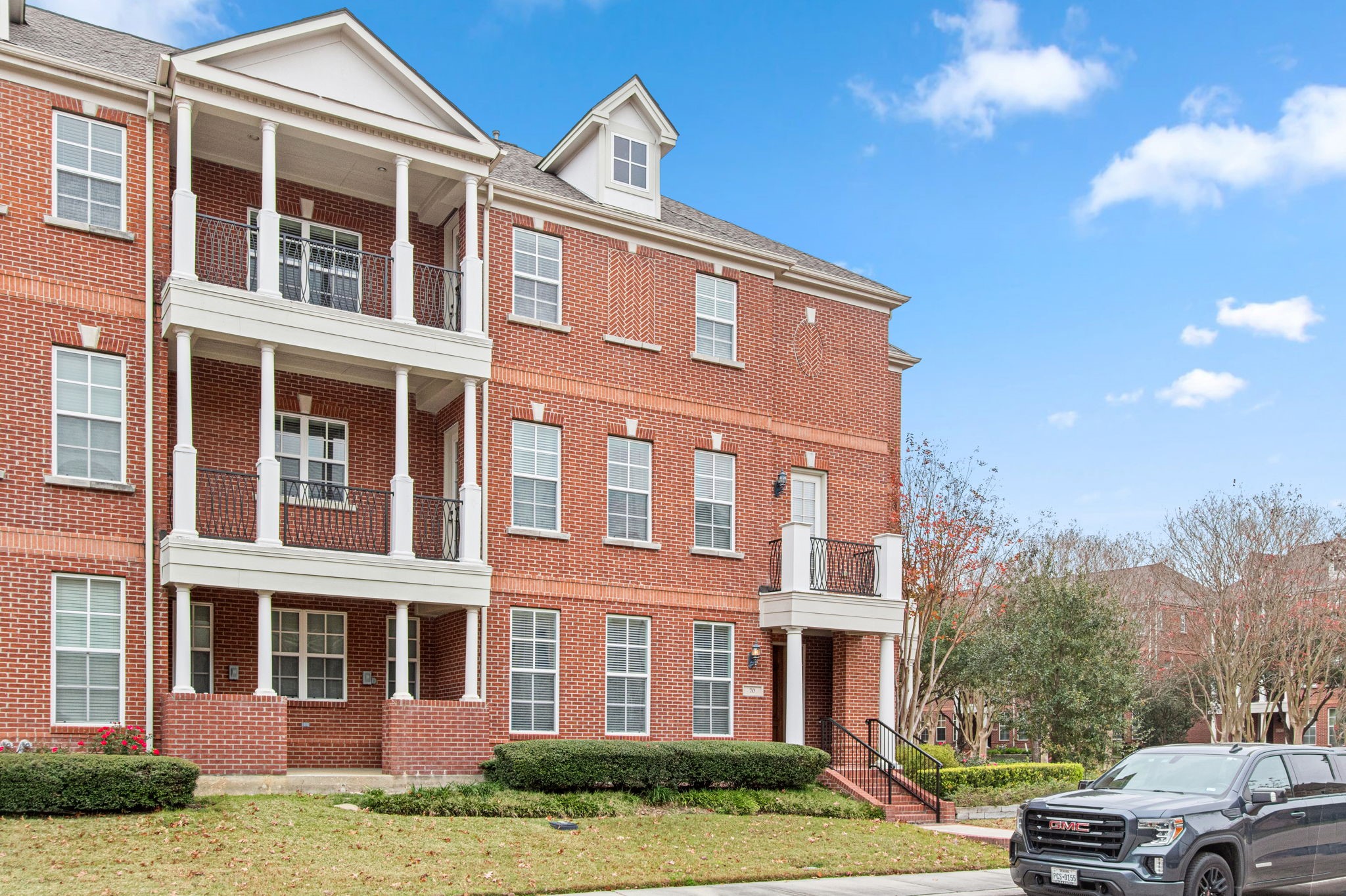 70 Shell Port Square The Woodlands, TX 77380 - Photo 2 of 50 a front view of a building with lot of cars and trees