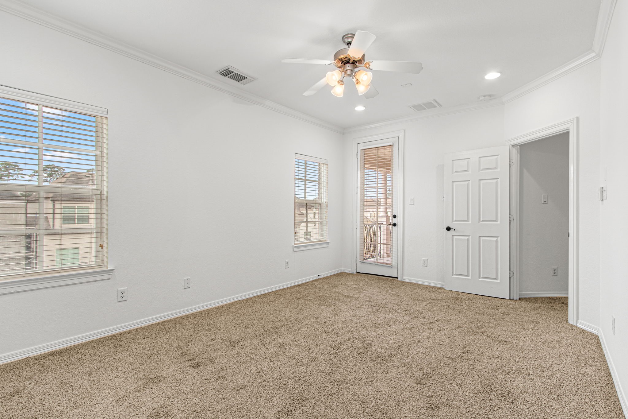 70 Shell Port Square The Woodlands, TX 77380 - Photo 22 of 50 an empty room with chandelier fan and windows