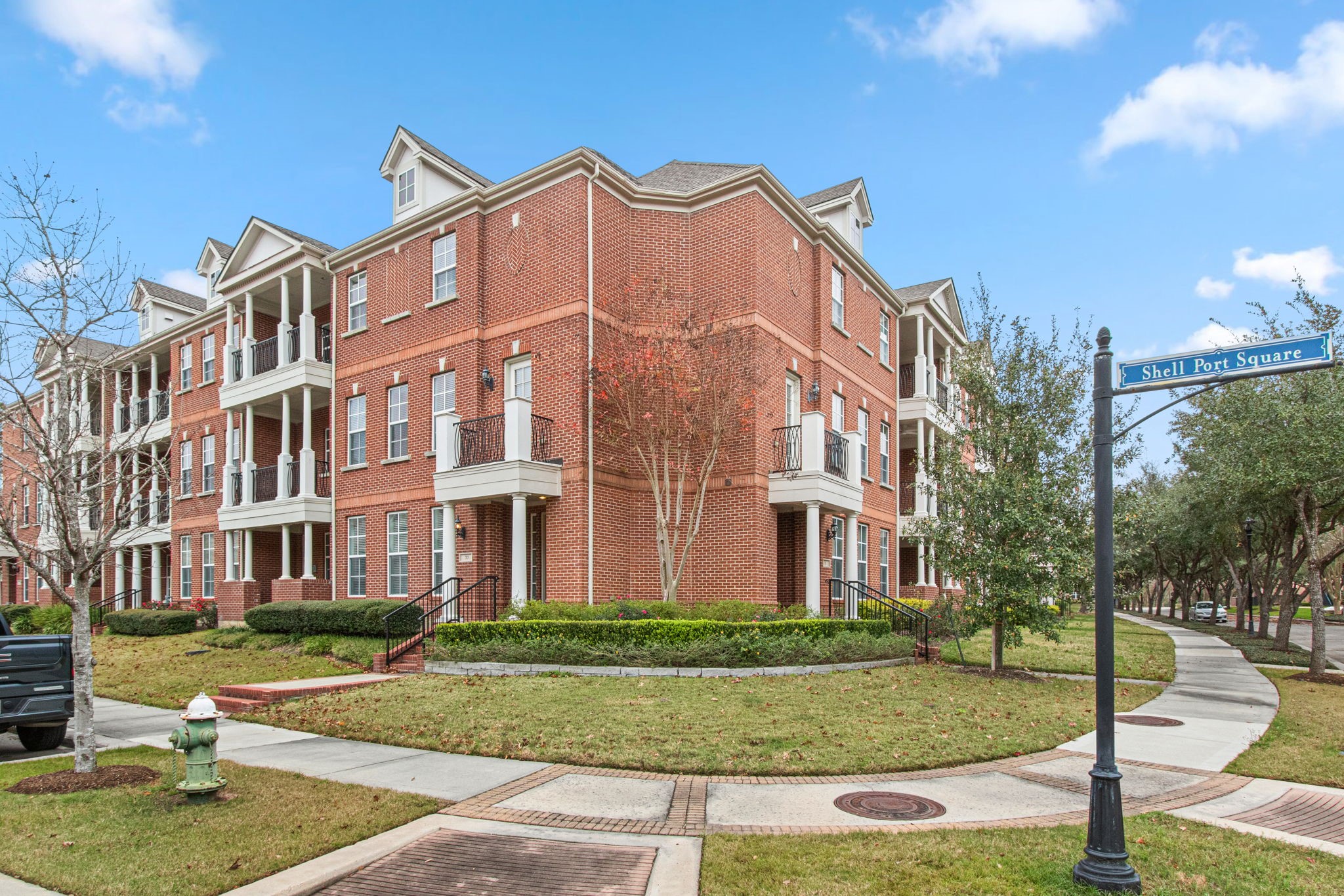 70 Shell Port Square The Woodlands, TX 77380 - Photo 3 of 50 a front view of a residential apartment building with a yard