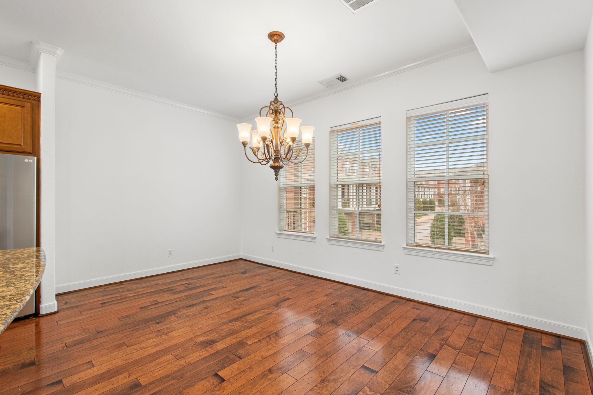 70 Shell Port Square The Woodlands, TX 77380 - Photo 10 of 50 a view of an empty room with wooden floor and a window