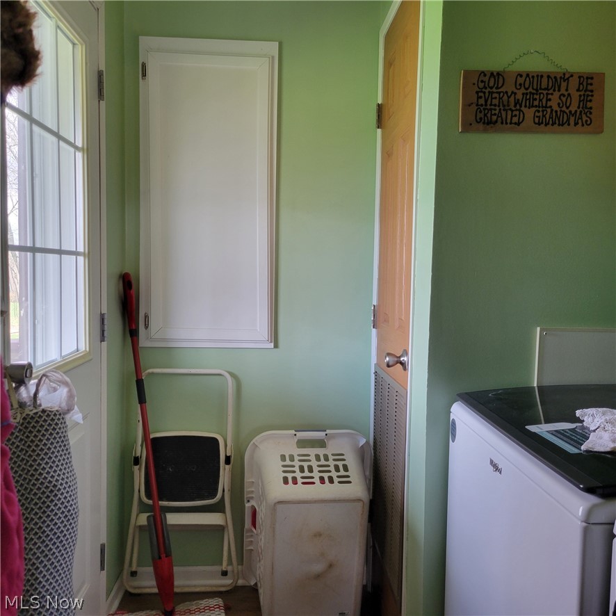 9531 McCormick Road Southwest Newcomerstown, OH 43832 - Photo 23 of 44 Clothes washing area featuring cabinets and washer / clothes dryer