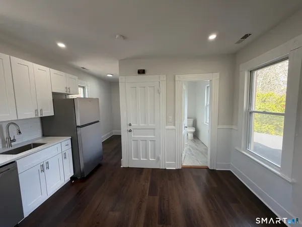 a kitchen with refrigerator and window