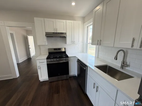 a kitchen with sink a stove and refrigerator