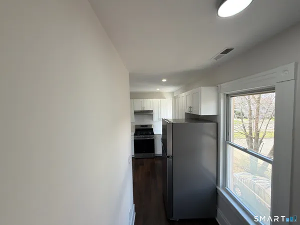 a view of a kitchen with a refrigerator a sink and dishwasher