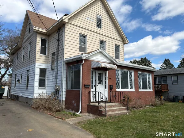 a front view of a house with a garden