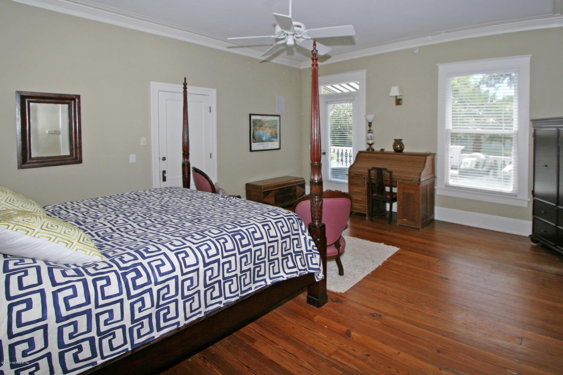 48 Water Street St. Augustine, FL 32084 - Photo 23 of 52 a bedroom with a bed dresser and a window