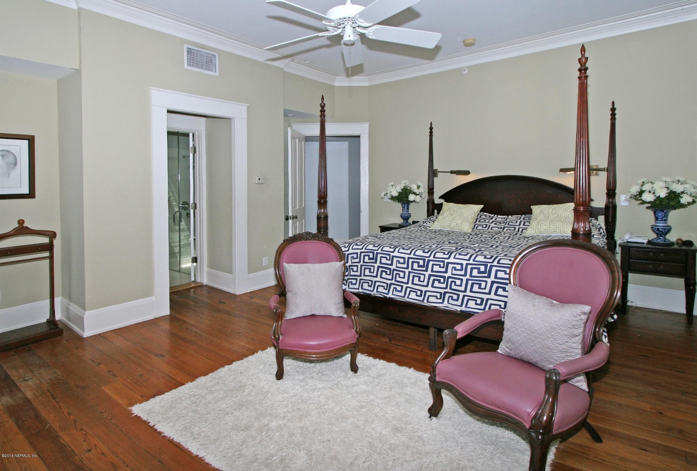 48 Water Street St. Augustine, FL 32084 - Photo 24 of 52 a bedroom with a bed and wooden floor