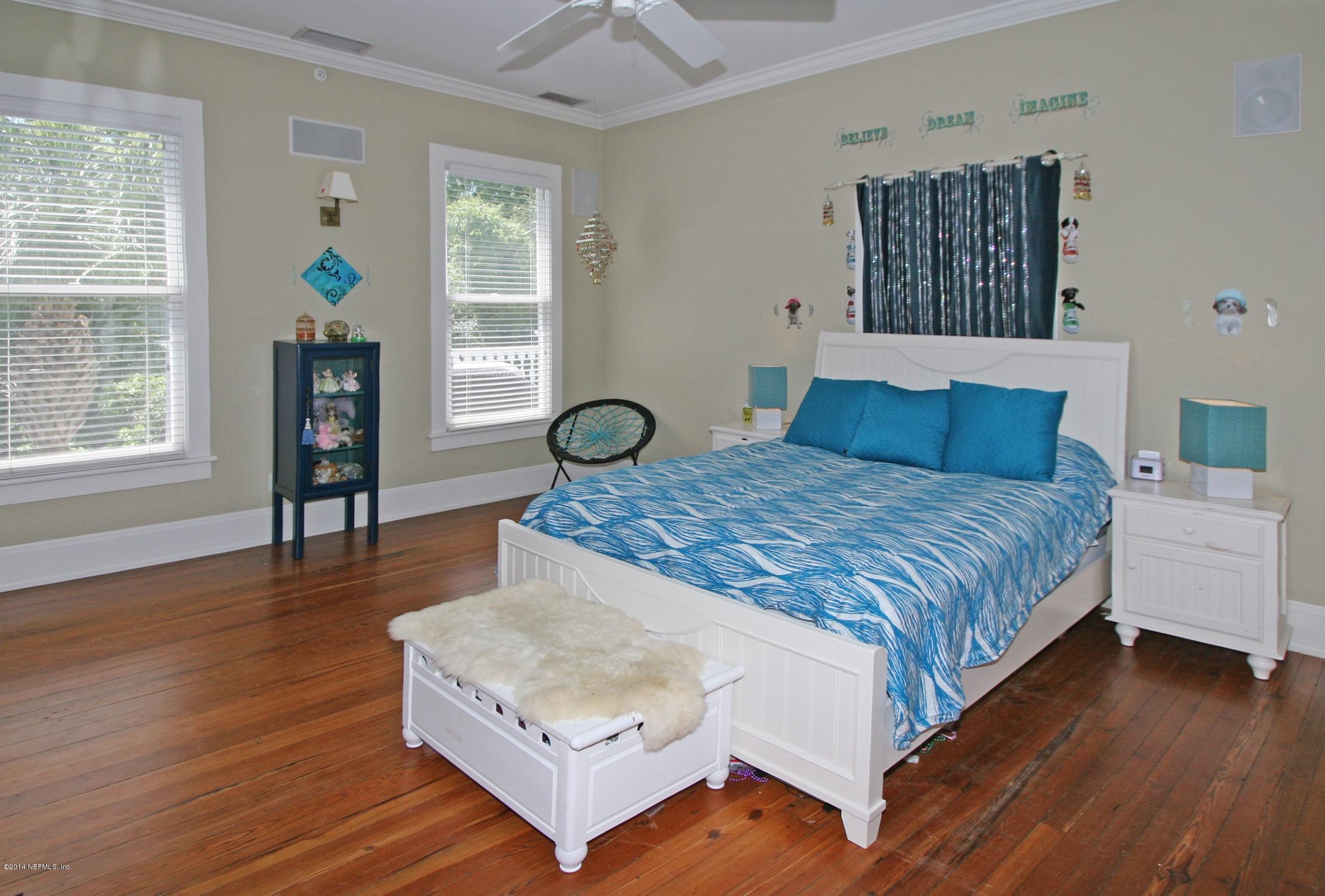 48 Water Street St. Augustine, FL 32084 - Photo 28 of 52 a bedroom with a bed and wooden floor