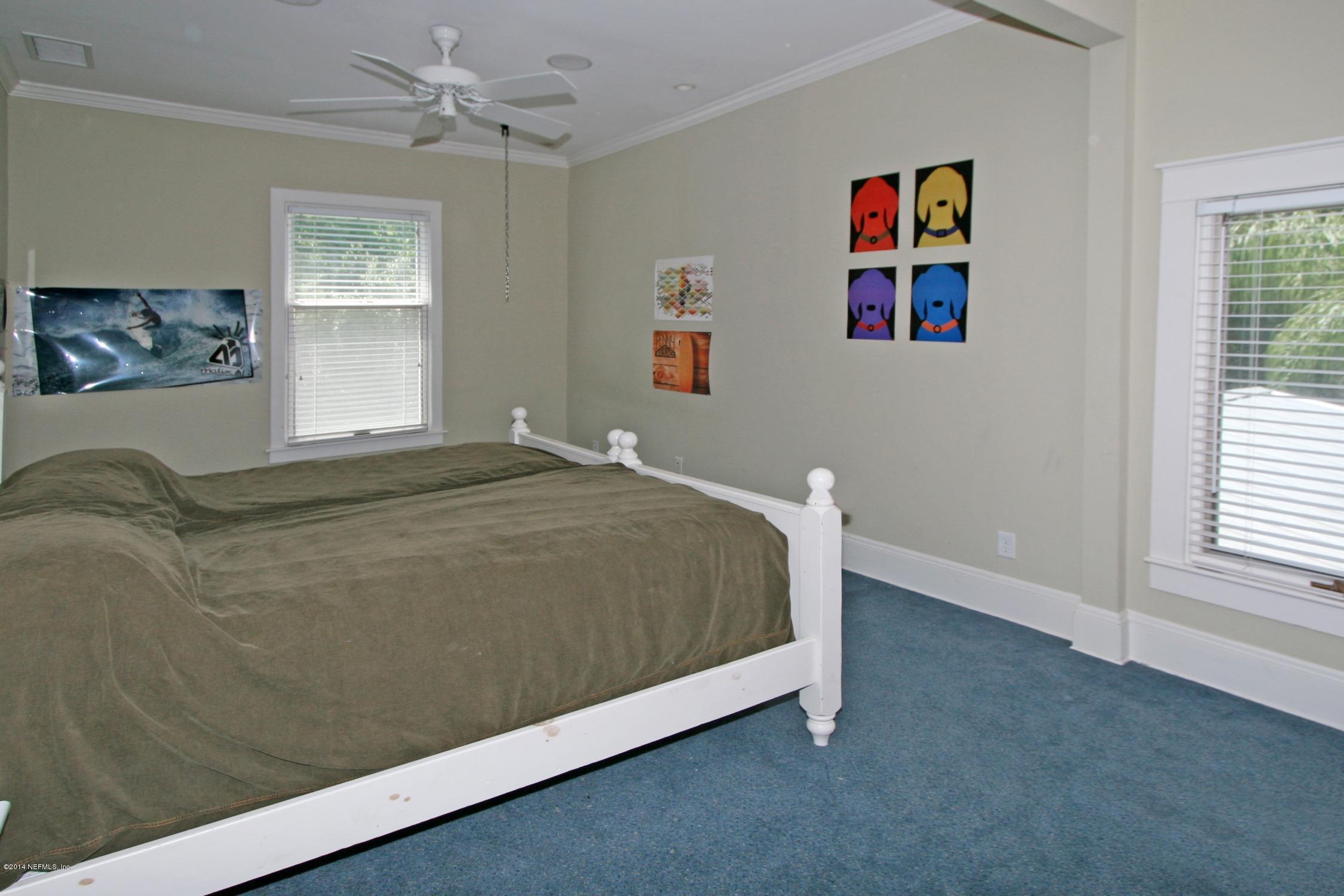 48 Water Street St. Augustine, FL 32084 - Photo 29 of 52 a bed sitting in a bedroom next to a window