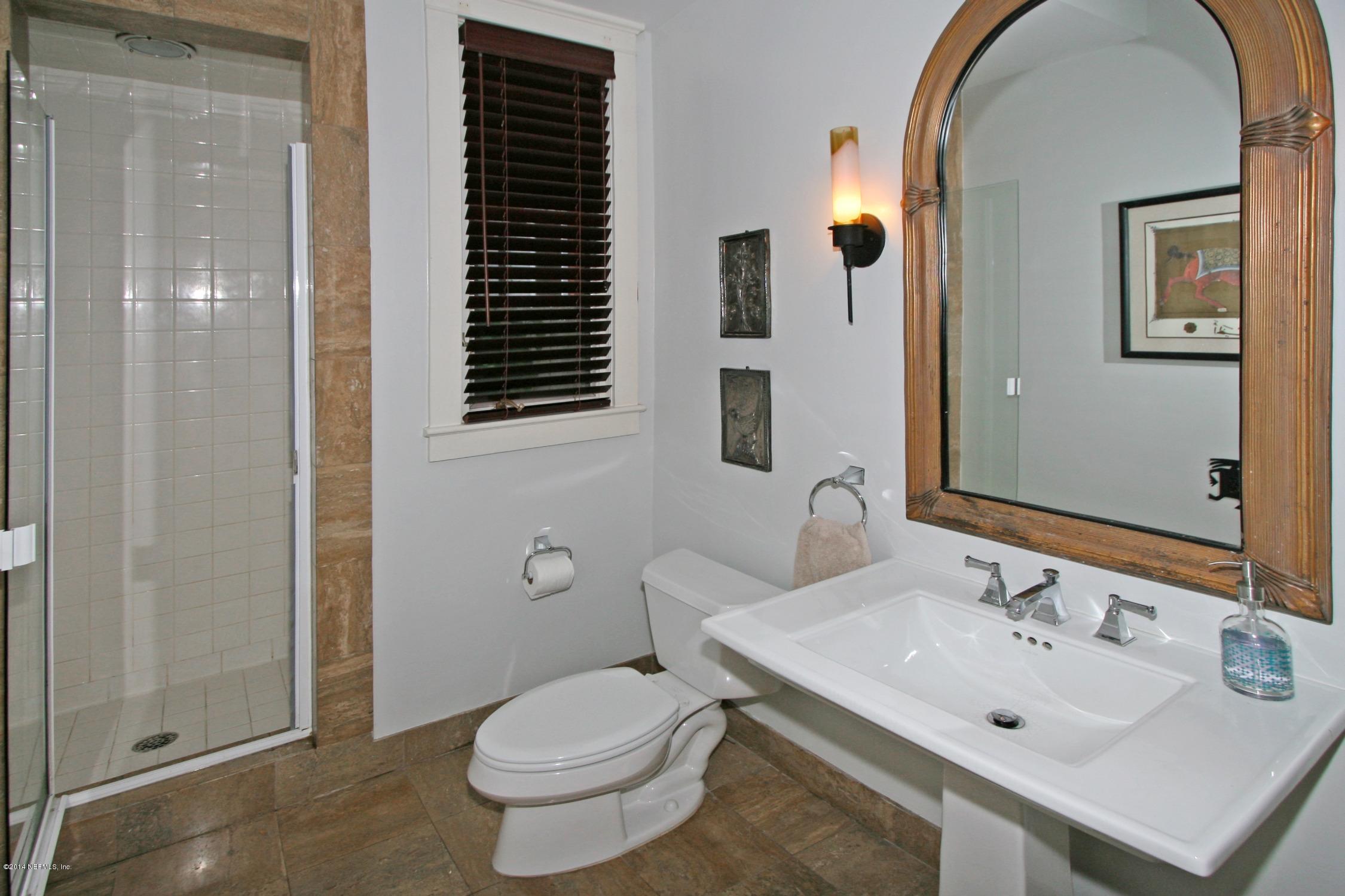 48 Water Street St. Augustine, FL 32084 - Photo 31 of 52 a bathroom with a sink and a mirror