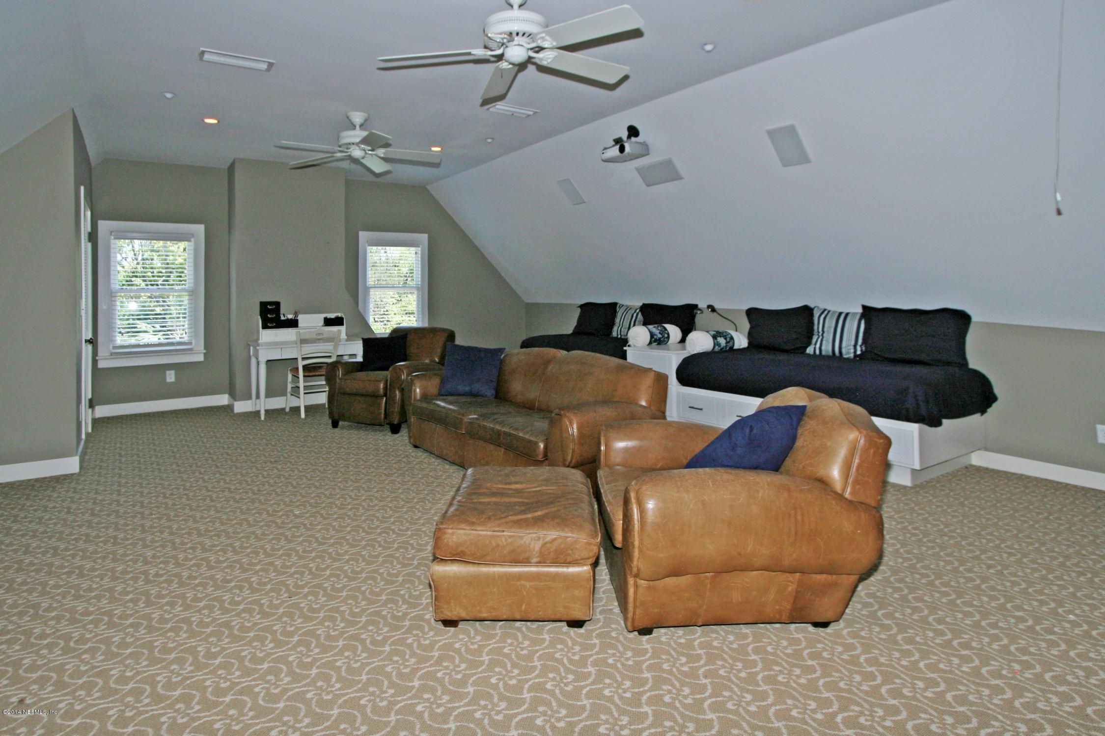 48 Water Street St. Augustine, FL 32084 - Photo 38 of 52 a living room with furniture and a chandelier